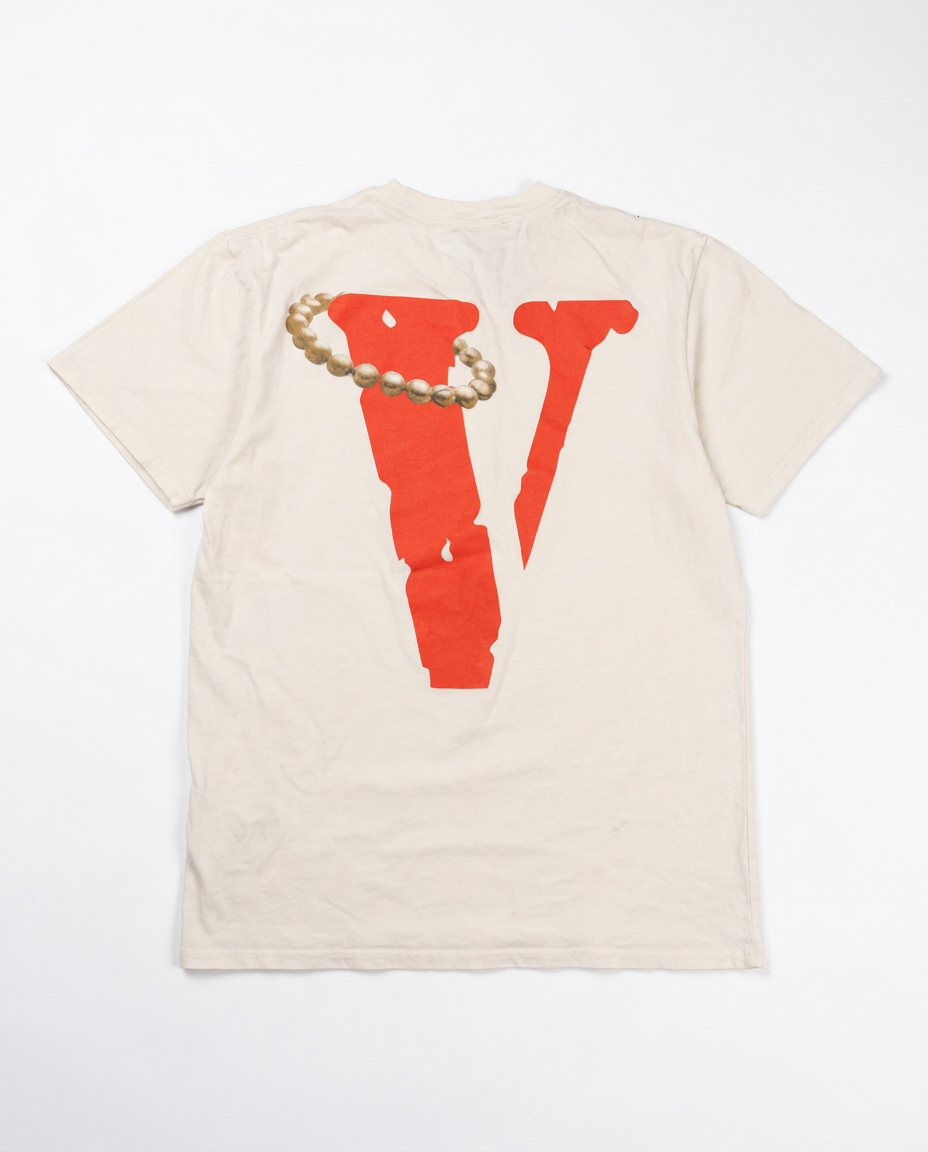 Vlone cream tee, back with red V and pearl necklace